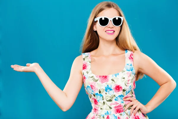 Cheerful young woman pointing something — Stockfoto