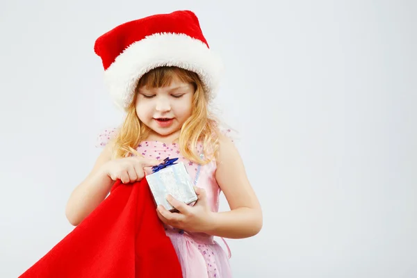 Little girl holding red bag for presents — Stock Photo, Image