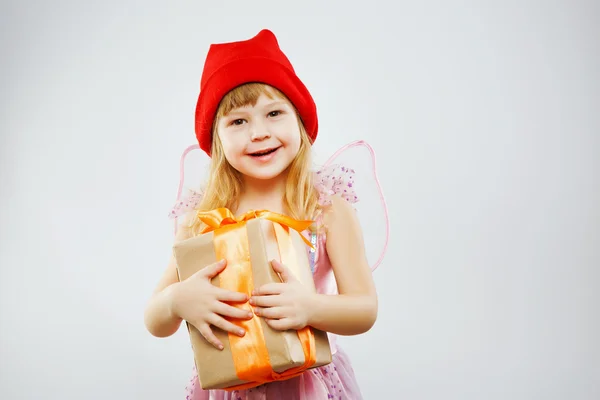 Pretty smiling girl holding big present — Stock Photo, Image