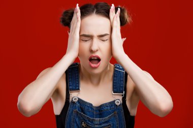 Young woman is posing like she has a headache