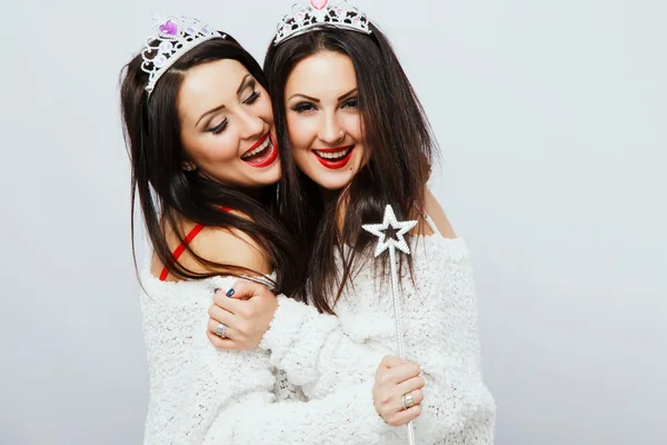 Young funny twins holding magic stick — Stock Photo, Image