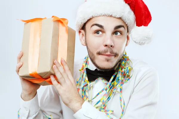 Intrigued man posing with present — Stock Photo, Image