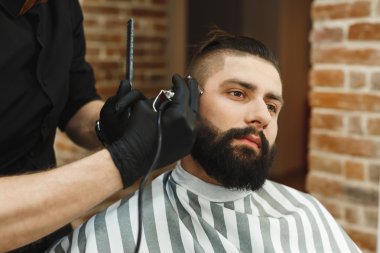 Man with dark hair doing a haircut clipart
