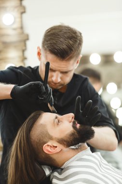 Barber making beard form for man clipart