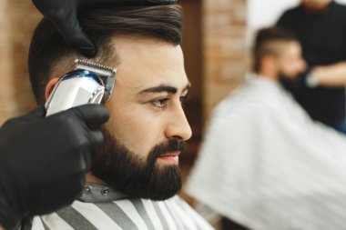 Adam siyah saçlı bir saç kesimi yapıyor