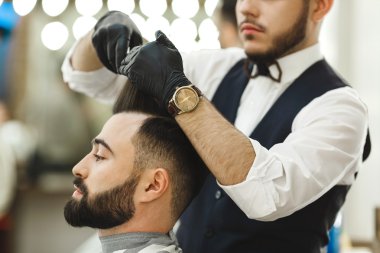 Barber doing haircuts for client clipart