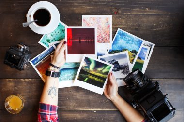 Woman's hands holding printed photos