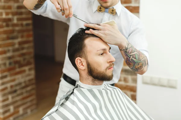 Man with dark hair doing a haircut — Stock Photo, Image