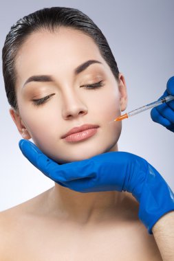 Young woman having beauty injection
