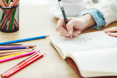 Woman's hands with white manicure drawing