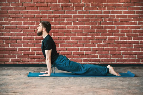 Handsome man doing yoga positions