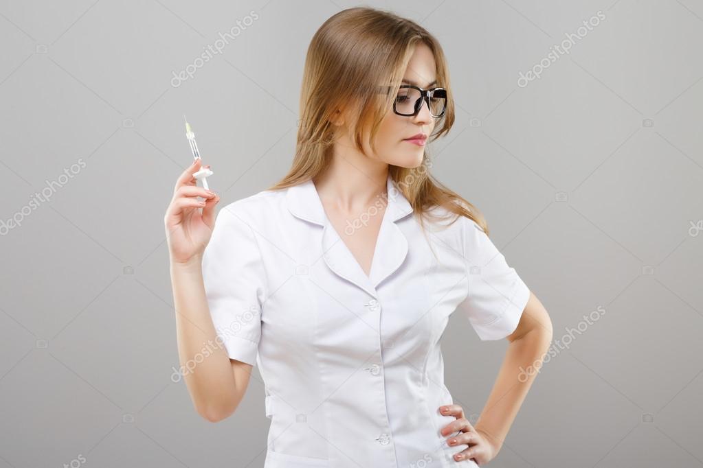 Attractive nurse with syringe Stock Photo by ©VelesStudio 124246548