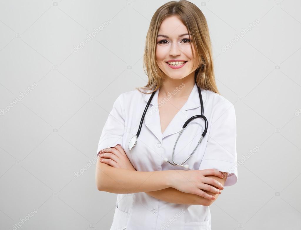 Beautiful nurse in white medical robe Stock Photo by ©VelesStudio