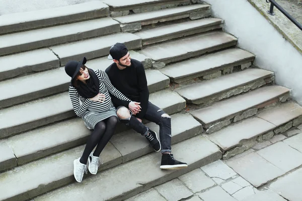 Chica embarazada y hombre sentado en las escaleras —  Fotos de Stock