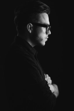 Side view of attractive young man on the black shirt