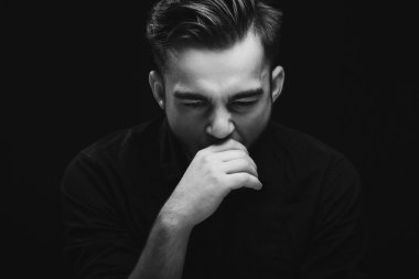 Young man with dark hair and beard in studio
