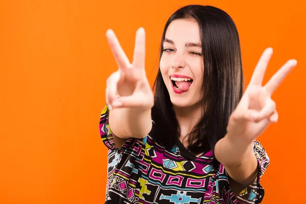 Pretty cheerful girl have fun on orange background, in studio — Stockfoto