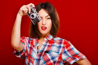 Passionate girl posing with retro camera