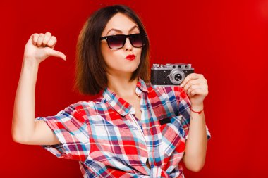 Cheerful woman holding retro camera