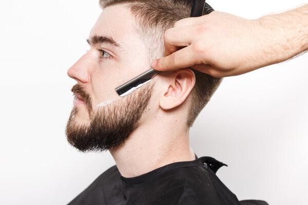 Close up portrait of a man getting a close shave