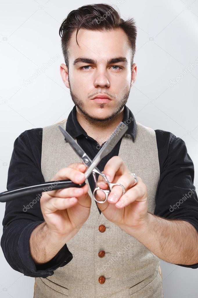Bearded man with razor and scissors