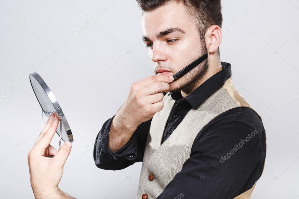 Brutal man combing his beard
