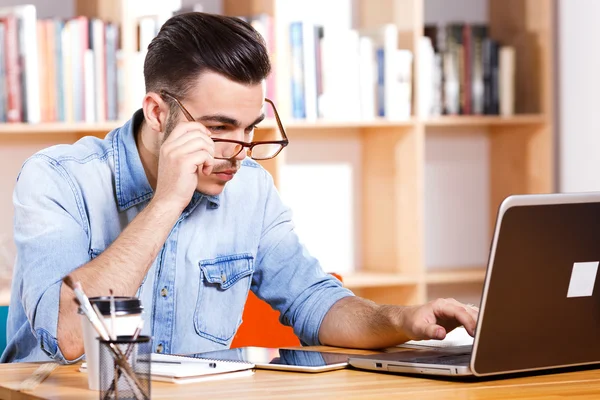 Hombre atractivo trabajando en su portátil — Foto de Stock