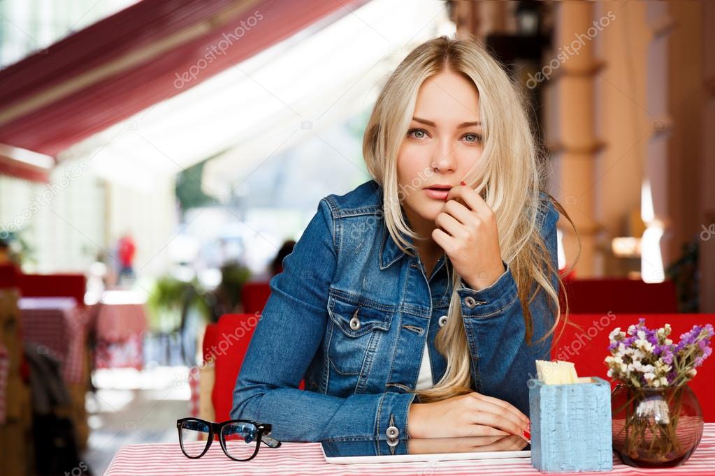 Young woman sitting in cozy cafe