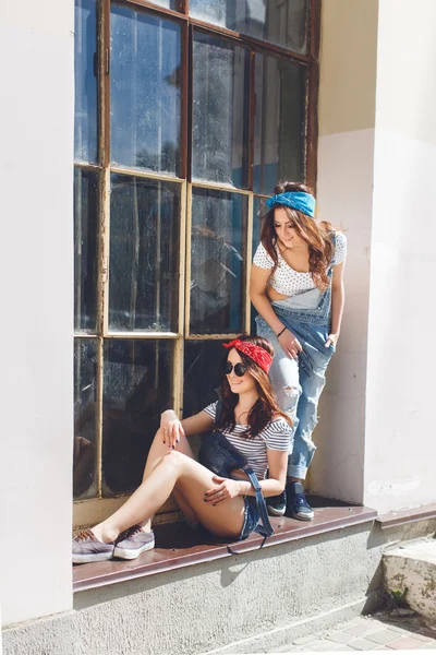 Twins sisters in front of window — стокове фото