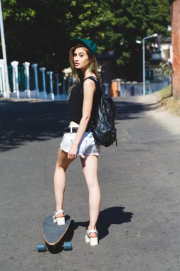 Blond girl riding on her skateboard