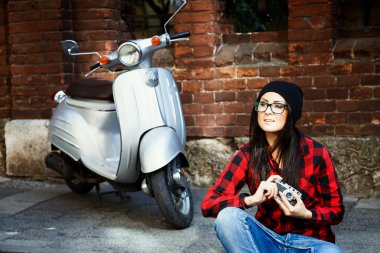 Attractive woman with retro camera