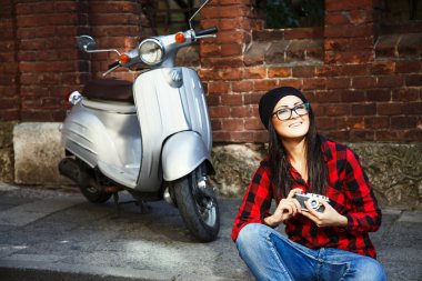 Smiling woman with retro camera