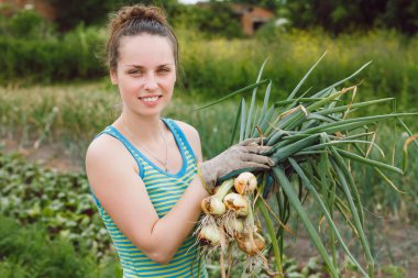 Woman with bunches of onion