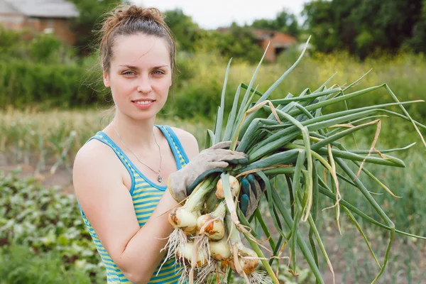 Woman with bunches of onion — 스톡 사진