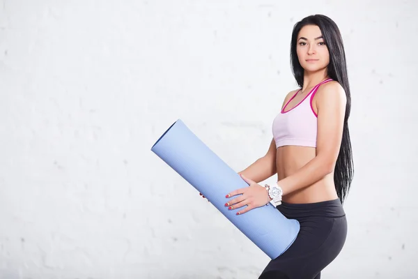 fitness woman holding mat