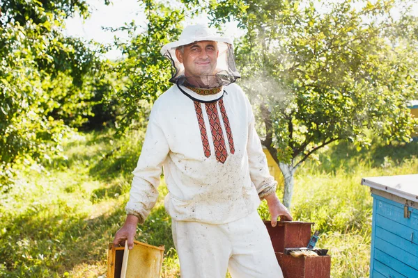 Apiarista fazendo inspeção em apiário — Fotografia de Stock