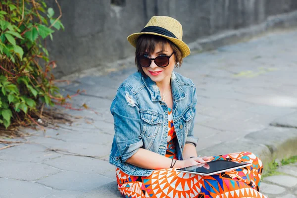 Woman tourist sitting on the curb — Stockfoto