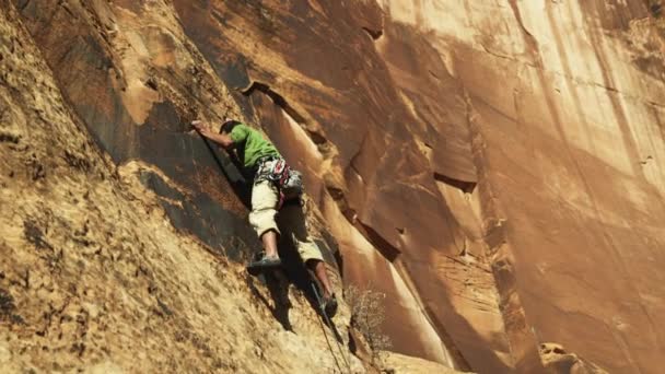 Genç adam kaya tırmanışı — Stok video