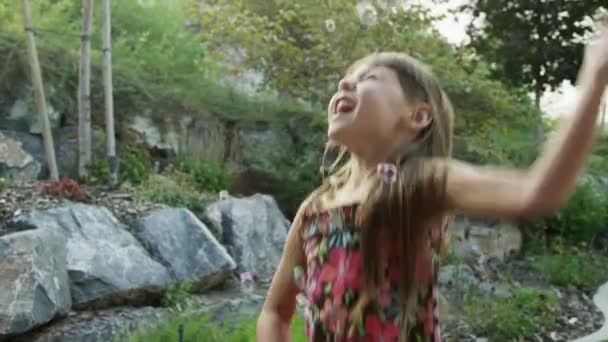 Girl playing with soap bubbles — Stock Video