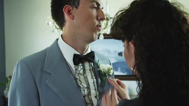 Mother adjusting son's tuxedo — Stock Video