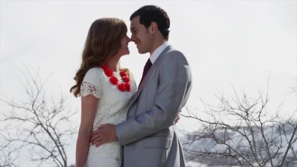 Bride and groom kissing outdoors — Stock Video