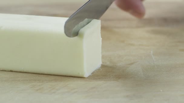 Hand slicing butter — Stock Video