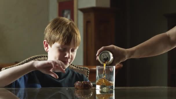 Boy having cola and doughnut — Stock Video