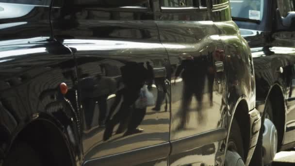 Pedestrians reflected in cabs — Stock Video