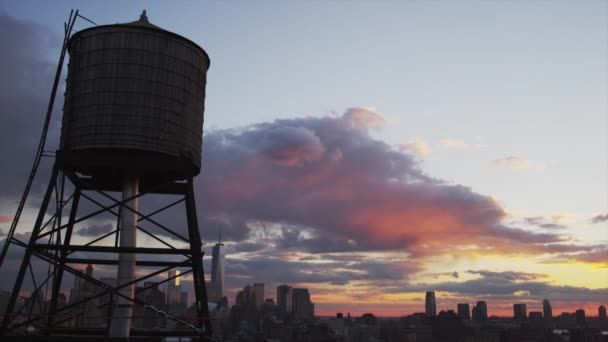 Water tower and cityscape at sunset — Stock Video