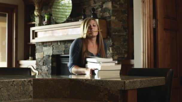 Girl carrying stack of books at home — Stock Video