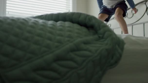 Boy having fun on bed — Stock Video