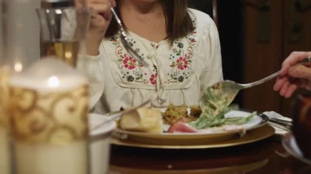 Grandmother adding food on granddaughter's plate — Stock Video