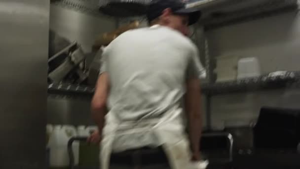 Hombres de limpieza contador de acero en la cocina — Vídeo de stock