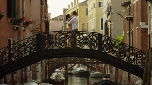 Couple standing and kissing on arch bridge — Stock Video